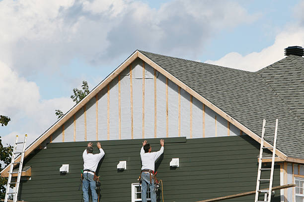 Professional Storm Damage Siding Repair technician working in Hampton, IL